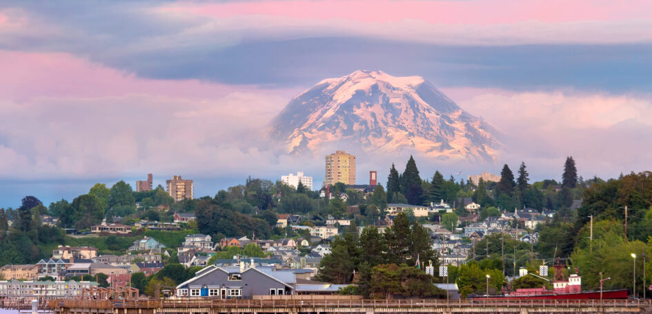 Mount Rainier over Tacoma Washington waterfront during alpenglow sunset evening